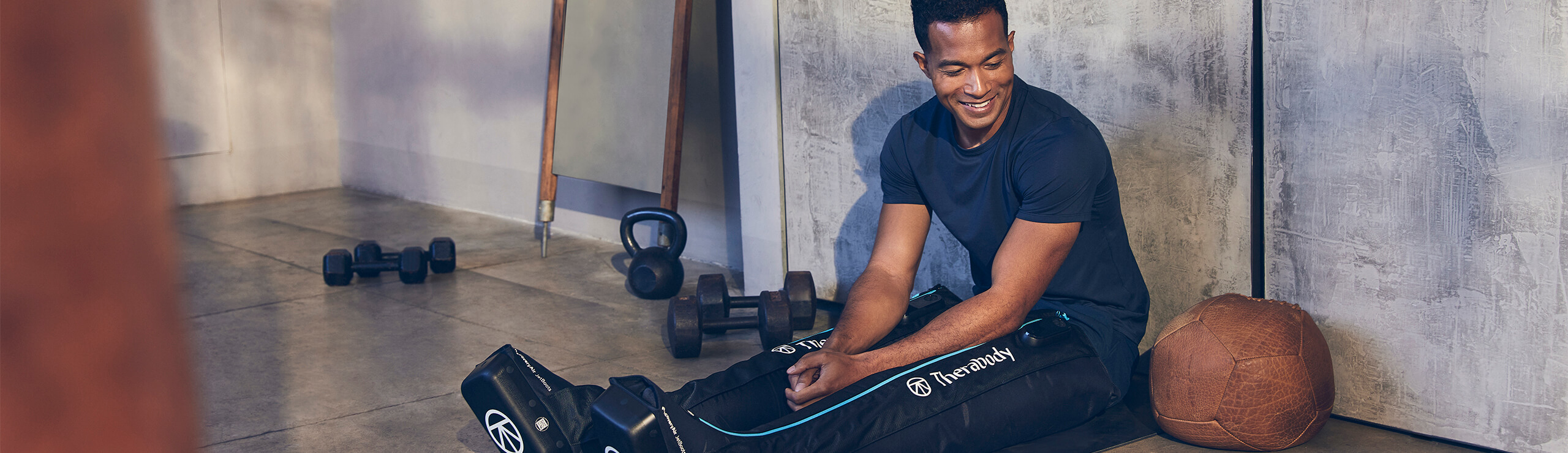 Man smiling using Therabody Jet Boots